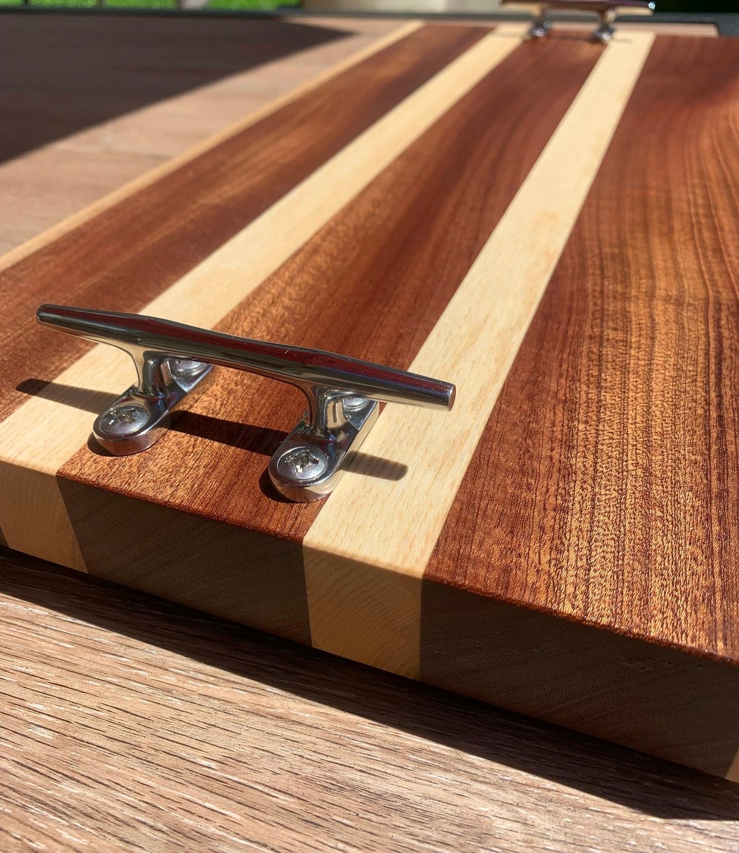 Sapele and ash cutting board with stainless steel boat cleats